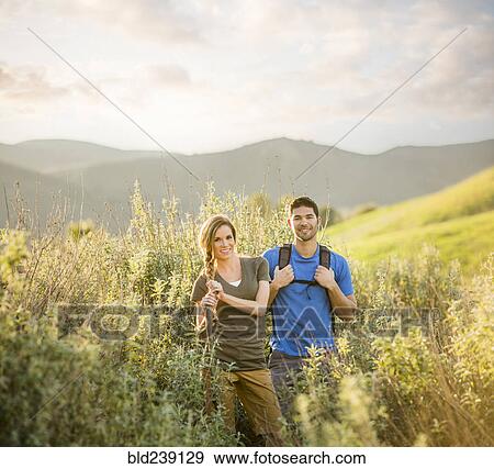Portrait of Caucasian couple hiking on hill View Large Photo Image Stock Photo - Portrait of Caucasian couple hiking on hill. Fotosearch