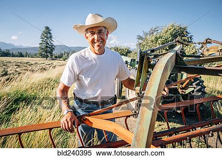 Portrait of Caucasian farmer standing near tractor View Large Photo Image Stock Photography - Portrait of Caucasian farmer standing near tractor. Fotosearch