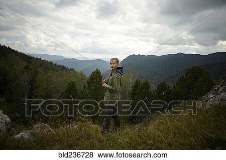Stock Photo - Portrait of Caucasian girl standing on mountain range. Fotosearch