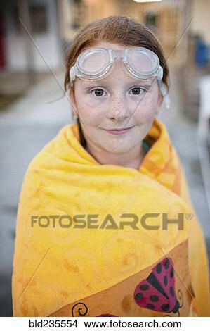 Picture - Portrait of Caucasian girl wrapped in towel after swimming. Fotosearch