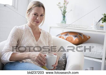 Stock Image - Portrait of Caucasian woman drinking coffee. Fotosearch