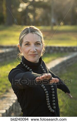 Portrait of Caucasian woman practicing yoga in park View Large Photo Image Picture - Portrait of Caucasian woman practicing yoga in park. Fotosearch