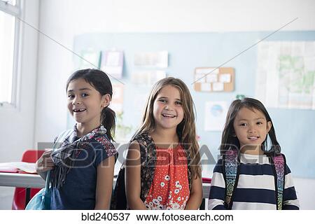 Portrait of girls smiling in classroom View Large Photo Image Stock Photo - Portrait of girls smiling in classroom. Fotosearch