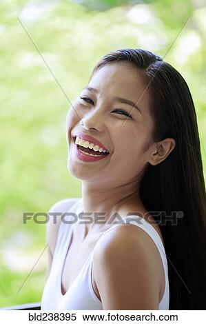 Portrait of laughing Asian teenage girl View Large Photo Image Stock Photography - Portrait of laughing Asian teenage girl. Fotosearch