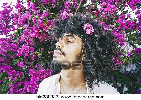 Portrait of Mixed Race man smelling flowers View Large Photo Image Stock Image - Portrait of Mixed Race man smelling flowers. Fotosearch