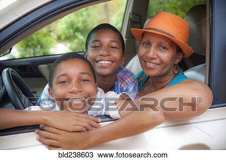 Portrait of mother and twin sons leaning on car window View Large Photo Image Stock Image - Portrait of mother and twin sons leaning on car window. Fotosearch