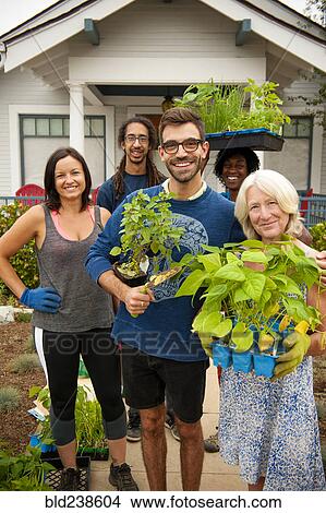 Portrait of neighbors holding plants near house View Large Photo Image Picture - Portrait of neighbors holding plants near house. Fotosearch