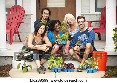 Portrait of neighbors sitting on front stoop holding plants View Large Photo Image Stock Photo - Portrait of neighbors sitting on front stoop holding plants. Fotosearch