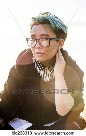Stock Image - Portrait of serious androgynous Asian woman. Fotosearch