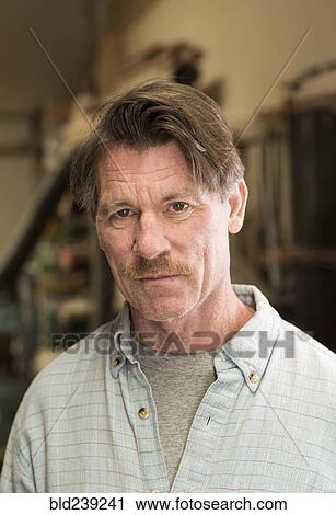 Stock Image - Portrait of serious Caucasian man. Fotosearch