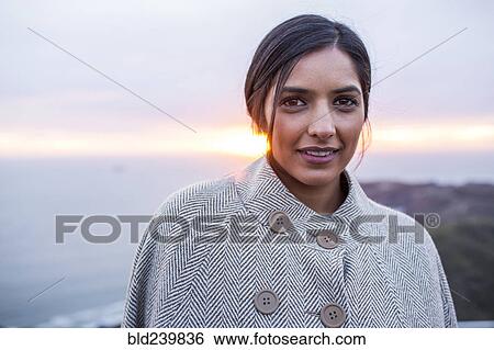 Portrait of serious Indian woman near ocean at sunset View Large Photo Image Stock Photograph - Portrait of serious Indian woman near ocean at sunset. Fotosearch