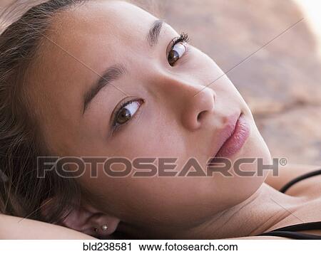 Stock Image - Portrait of serious Mixed Race girl. Fotosearch
