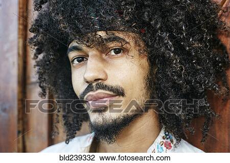 Stock Image - Portrait of serious Mixed Race man. Fotosearch