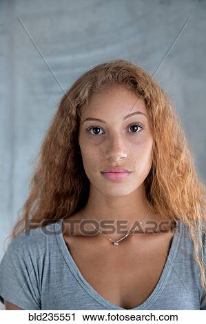 Stock Image - Portrait of serious Mixed Race woman. Fotosearch