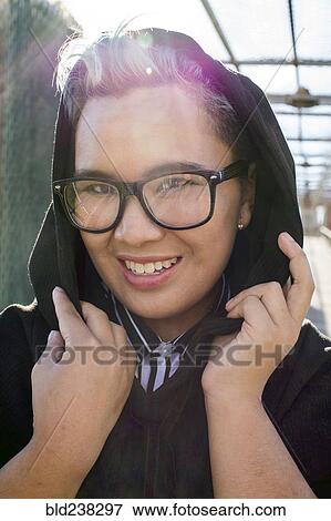 Stock Photo - Portrait of smiling androgynous Asian woman. Fotosearch