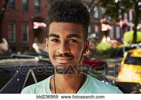 Stock Photo - Portrait of smiling Black man in city. Fotosearch