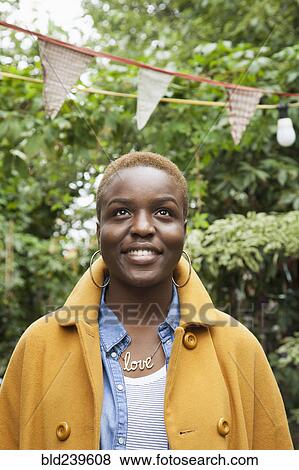 Portrait of smiling Black woman looking up View Large Photo Image Stock Photo - Portrait of smiling Black woman looking up. Fotosearch