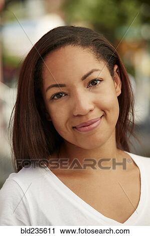 Stock Image - Portrait of smiling Black woman. Fotosearch