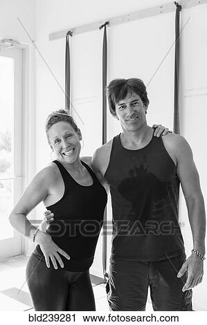 Portrait of smiling Caucasian couple hugging in gymnasium View Large Photo Image Stock Image - Portrait of smiling Caucasian couple hugging in gymnasium. Fotosearch