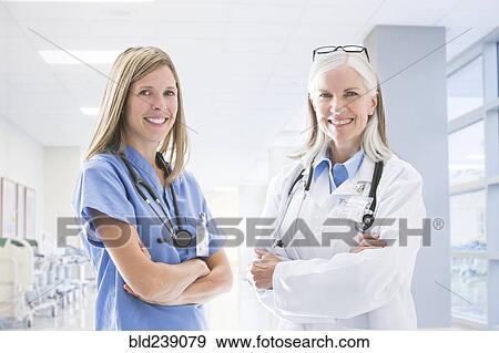 Stock Photo - Portrait of smiling Caucasian doctor and nurse. Fotosearch