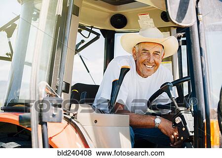 Portrait of smiling Caucasian farmer in tractor View Large Photo Image Stock Photo - Portrait of smiling Caucasian farmer in tractor. Fotosearch