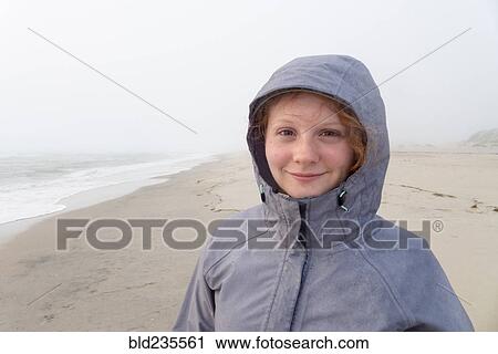 Portrait of smiling Caucasian girl on cold beach View Large Photo Image Stock Image - Portrait of smiling Caucasian girl on cold beach. Fotosearch