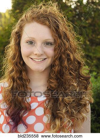 Stock Photo - Portrait of smiling Caucasian girl with red hair. Fotosearch