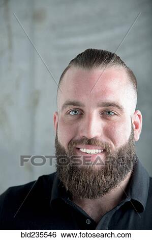 Stock Photograph - Portrait of smiling Caucasian man with beard. Fotosearch