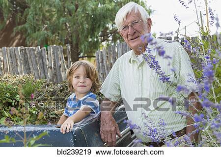 Stock Photo - Portrait of smiling Caucasian grandfather and grandson at truck. Fotosearch