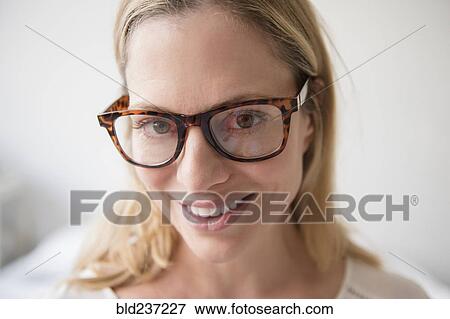 Stock Photo - Portrait of smiling Caucasian woman wearing eyeglasses. Fotosearch