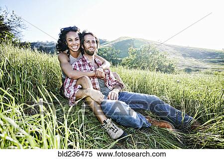 Portrait of smiling couple hugging on hill View Large Photo Image Stock Photography - Portrait of smiling couple hugging on hill. Fotosearch