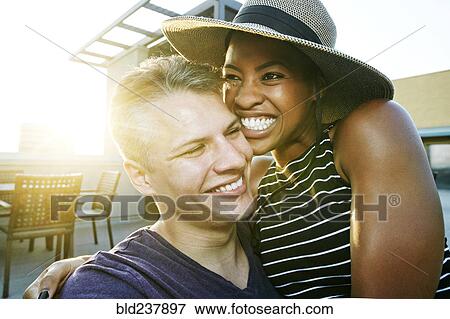 Portrait of smiling couple on rooftop View Large Photo Image Stock Photo - Portrait of smiling couple on rooftop. Fotosearch