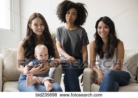 Portrait of smiling friends with baby View Large Photo Image Stock Photo - Portrait of smiling friends with baby. Fotosearch
