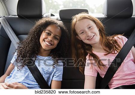 Portrait of smiling girls in car View Large Photo Image Stock Image - Portrait of smiling girls in car. Fotosearch