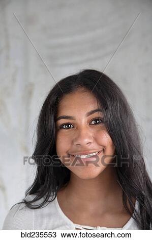 Stock Image - Portrait of smiling Hispanic girl. Fotosearch