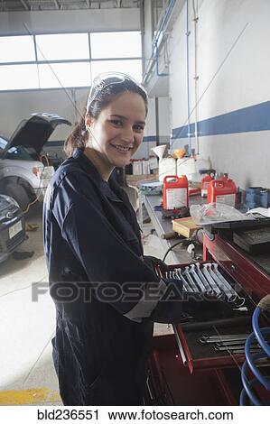 Stock Image - Portrait of smiling Hispanic mechanic. Fotosearch