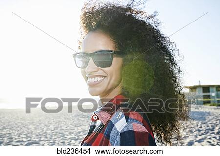 Portrait of smiling Hispanic woman at beach View Large Photo Image Picture - Portrait of smiling Hispanic woman at beach. Fotosearch