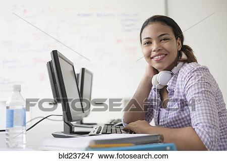 Stock Photo - Portrait of smiling Hispanic woman in computer lab. Fotosearch