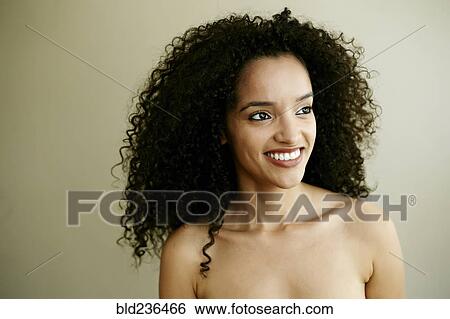 Stock Photograph - Portrait of smiling Hispanic woman looking away. Fotosearch