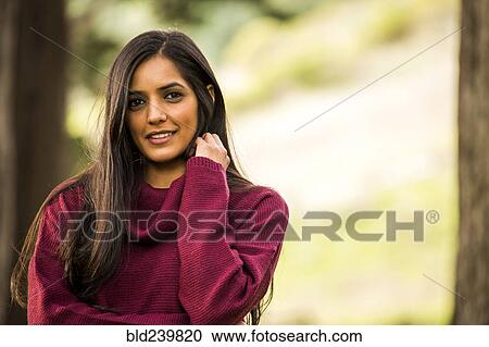 Portrait of smiling Indian woman wearing sweater View Large Photo Image Stock Image - Portrait of smiling Indian woman wearing sweater. Fotosearch