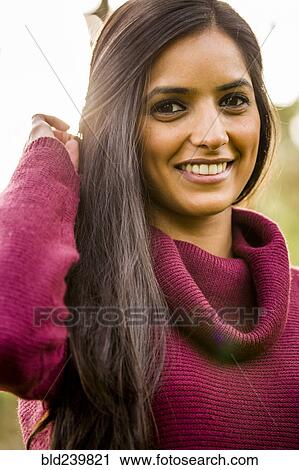 Portrait of smiling Indian woman wearing sweater View Large Photo Image Stock Image - Portrait of smiling Indian woman wearing sweater. Fotosearch