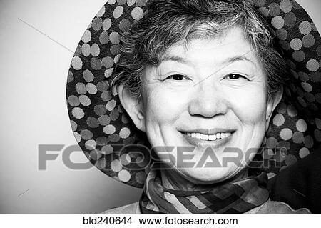 Portrait of smiling Japanese woman wearing hat View Large Photo Image Picture - Portrait of smiling Japanese woman wearing hat. Fotosearch