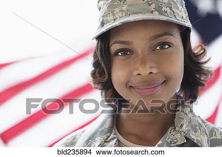 Picture - Portrait of smiling Mixed Race soldier near American flag. Fotosearch