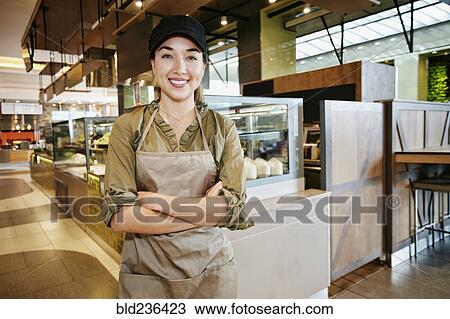 Stock Image - Portrait of smiling Mixed Race worker in food court. Fotosearch