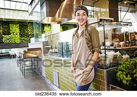 Stock Photography - Portrait of smiling Mixed Race worker in food court. Fotosearch