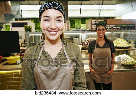 Picture - Portrait of smiling Mixed Race workers in food court. Fotosearch