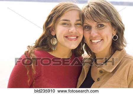 Stock Image - Portrait of smiling mother and daughter. Fotosearch