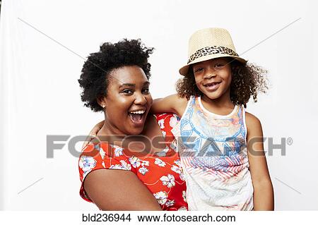 Picture - Portrait of smiling mother holding daughter. Fotosearch