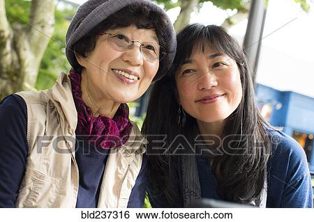 Portrait of smiling older Japanese mother and daughter View Large Photo Image Stock Photograph - Portrait of smiling older Japanese mother and daughter . Fotosearch