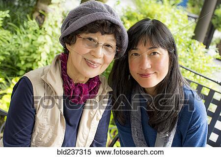 Portrait of smiling older Japanese mother and daughter View Large Photo Image Stock Photography - Portrait of smiling older Japanese mother and daughter . Fotosearch